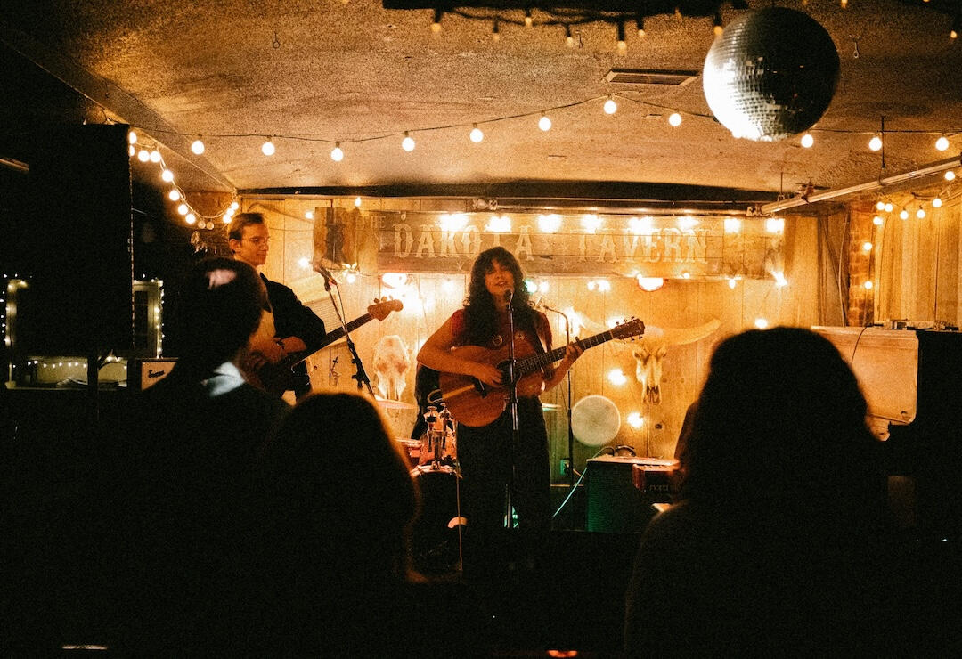 Photo of a band from the back of a crowd